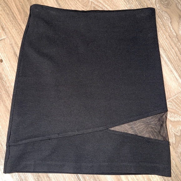Black mini skirt BB Dakota featuring a unique diagonal sheer mesh panel detail.4 - Picture 1 of 8